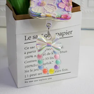 Colorful macaron bead phone charm with iridescent bow and pastel resin beads