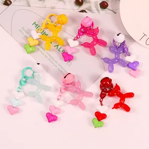 Detail of colorful balloon dog keychains with matching heart charms and bells