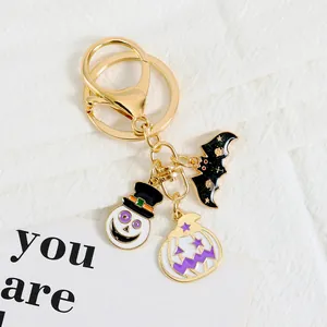 Detail of Halloween keychain with enamel bat, ghost snowman, and pumpkin star pendants