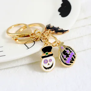 Halloween keychain with ghost, pumpkin and bat charms on golden metal alloy ring