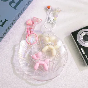 Cute resin balloon dog keychains in pink and cream with colorful beads and heart charms