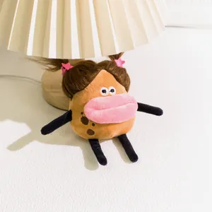 Macro detail of cartoon potato plush keychain with big lips and star hair clips
