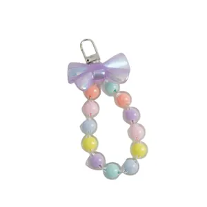 Macaron colorful beaded phone charm with a purple bow and silver metal lobster clasp