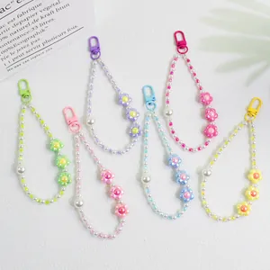 Close-up of colorful floral bead phone charms with pearls and lobster clasps in six shades