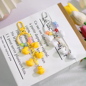 Cute duck keychains with colorful smile beads and lobster clasps in yellow and white