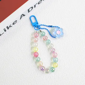 Macro shot of colorful beaded keychain with pastel acrylic flower and vibrant lobster clasp