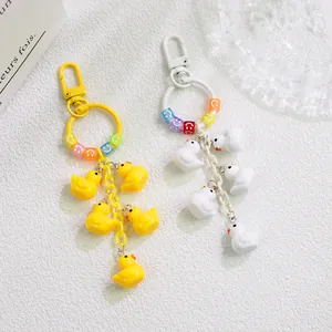 Detail of cute duck charms and smiley face beads on a vibrant cartoon keychain
