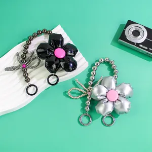 Chic padded flower keychain set in black and silver with metallic finish and metal ring