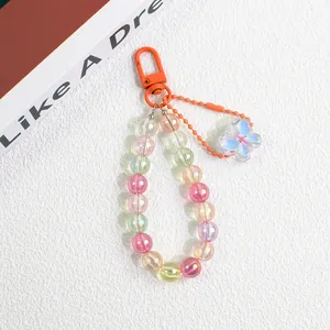 Macro shot of colorful acrylic beads keychain with orange clasp and butterfly pendant