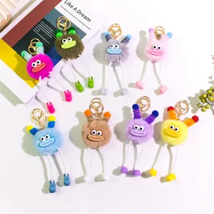 Macro detail of plush potato monster keychains with long legs and funny sausage lips