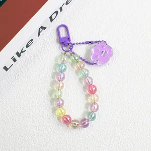 Detail of colorful gradient beads keychain featuring a purple acrylic cat paw charm and hook