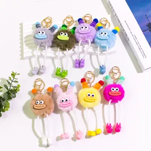 Macro shot of fluffy monster keychains in diverse colors with cute rope legs