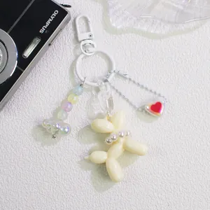 Detailed cream balloon dog keychain with faux pearls, colorful beads and acrylic links