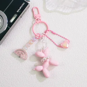 Detail view of pink balloon dog keychain with pearls, heart charm and rainbow beads