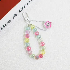 Close-up of macaron color beads with transparent star pendant and black smiley face detail