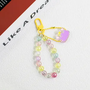 Detail of colorful acrylic beaded keychain with purple crown pendant and yellow clasp
