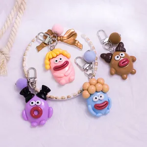 Porte-clés de dessin animé avec bouche de saucisse et pompon en quatre couleurs vives