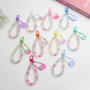 Colorful acrylic beaded keychain set with cute charms like smiling faces and strawberries