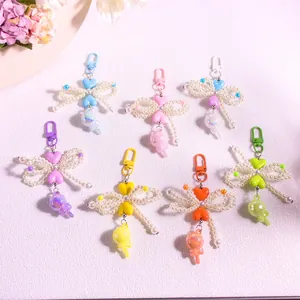 Detailed view of colorful heart beaded keychains with ribbon bows in seven pastel shades