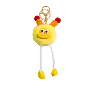 Funny fuzzy potato keychain with long legs and orange horns on white background