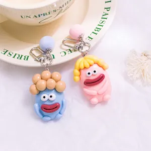 Porte-clés monstres mignons avec de grands yeux et boules en peluche, rose et bleu