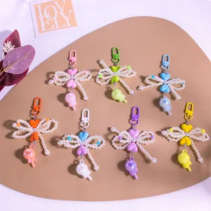 Flat lay of colorful lollipop keychains with pearl bows and heart charms in macaron colors