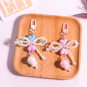 Close-up of pearl beaded heart lollipop keychain with bow and macaron colored accents