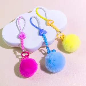 Colorful beaded phone charm with marble heart pendant and fluffy pompom accessory