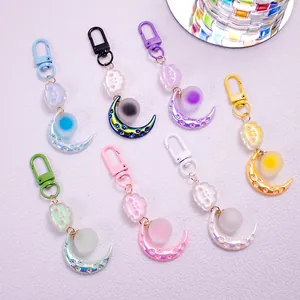 Set of seven colorful cartoon moon and cloud keychains with matte finish and lobster clasps