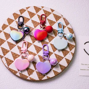 Detailed view of colorful heart keychains with spring hooks and decorative beads