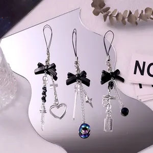 Gothic Y2K charms with black bows, silver crosses and syringe pendants on mirrors