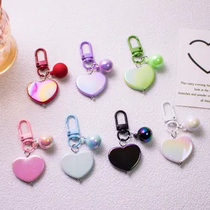 Macro shot of colorful pearlescent heart keychains with spring ring clasps in seven colors