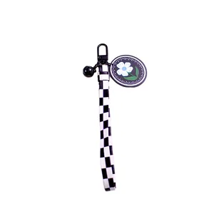 Checkerboard pattern keychain with daisy charm and black snap hook for bags