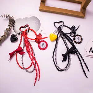 Macro view of woven leather bag charms with poker chips, heart pendants and dice details