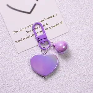 Detail of a purple heart-shaped keychain with iridescent finish and matching lobster clasp