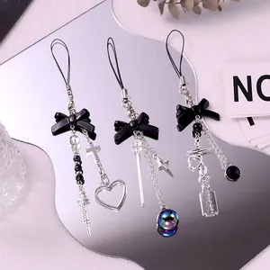 Y2K gothic black bow phone charm with silver cross and syringe charms on mirror