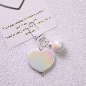 Close-up of iridescent heart keychain with pearlescent resin finish and white clip