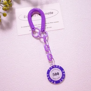 Detail of purple spiral spring keychain with poker chip pendant and plastic links