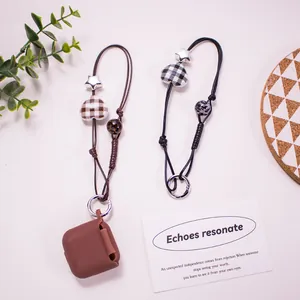 Detail of woven phone charms with heart and star beads and spring metal buckles