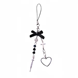 Gothic Y2K phone charm with black bow, metal cross, syringe pendant and heart detail