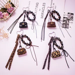Chic 4-piece set of mini leather coin purse keychains with leopard beads and bows
