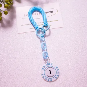 Close-up of blue spiral spring keychain with Monte Carlo Poker Club acrylic pendant