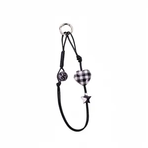 Plaid heart and star keychain with leopard bead on black braided cord lanyard