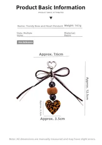 Detail of leopard print heart keychain with resin beads and brown pom pom charm