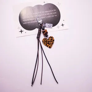 Leopard print heart keychain with tassels, beads and woven bow for handbag decoration
