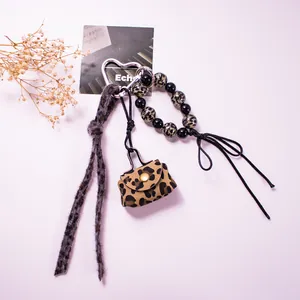 Detailed leopard print charm set with heart clasp, plush strap, and mini pouch
