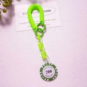 Close-up of neon green spiral spring keychain with poker club chip and plastic links