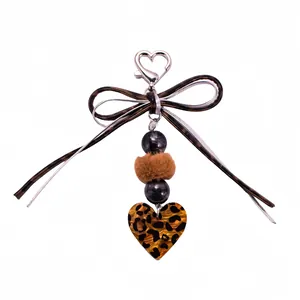 Leopard print heart keychain with silk bow and beads on a clean white background