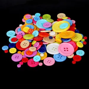 Colorful assorted plastic buttons in various sizes and vibrant colors on black background