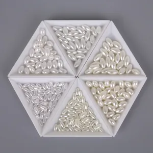 Macro view of oval ABS imitation pearl beads in white shades for DIY jewelry making